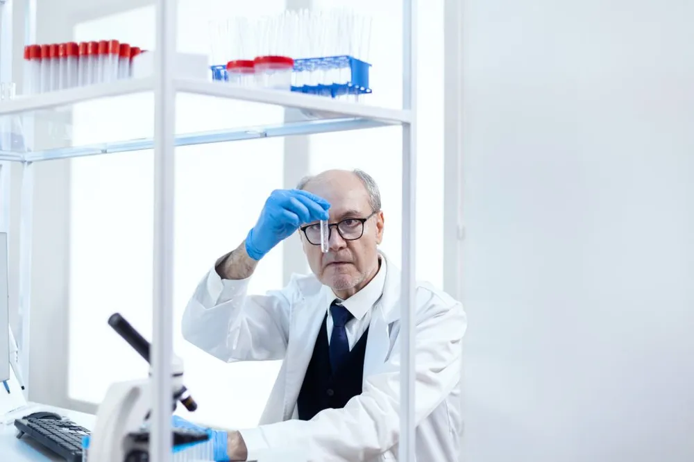 Scientist analysing a solution in a sterile chemistry lab